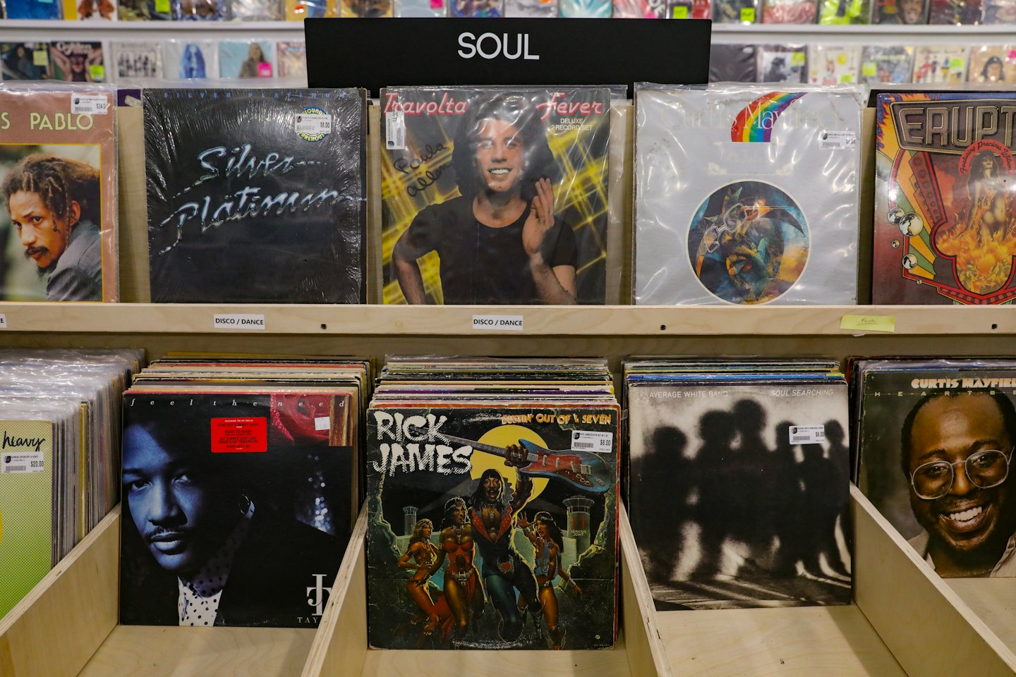 Vintage vinyl records displayed on shelves in a music store.
